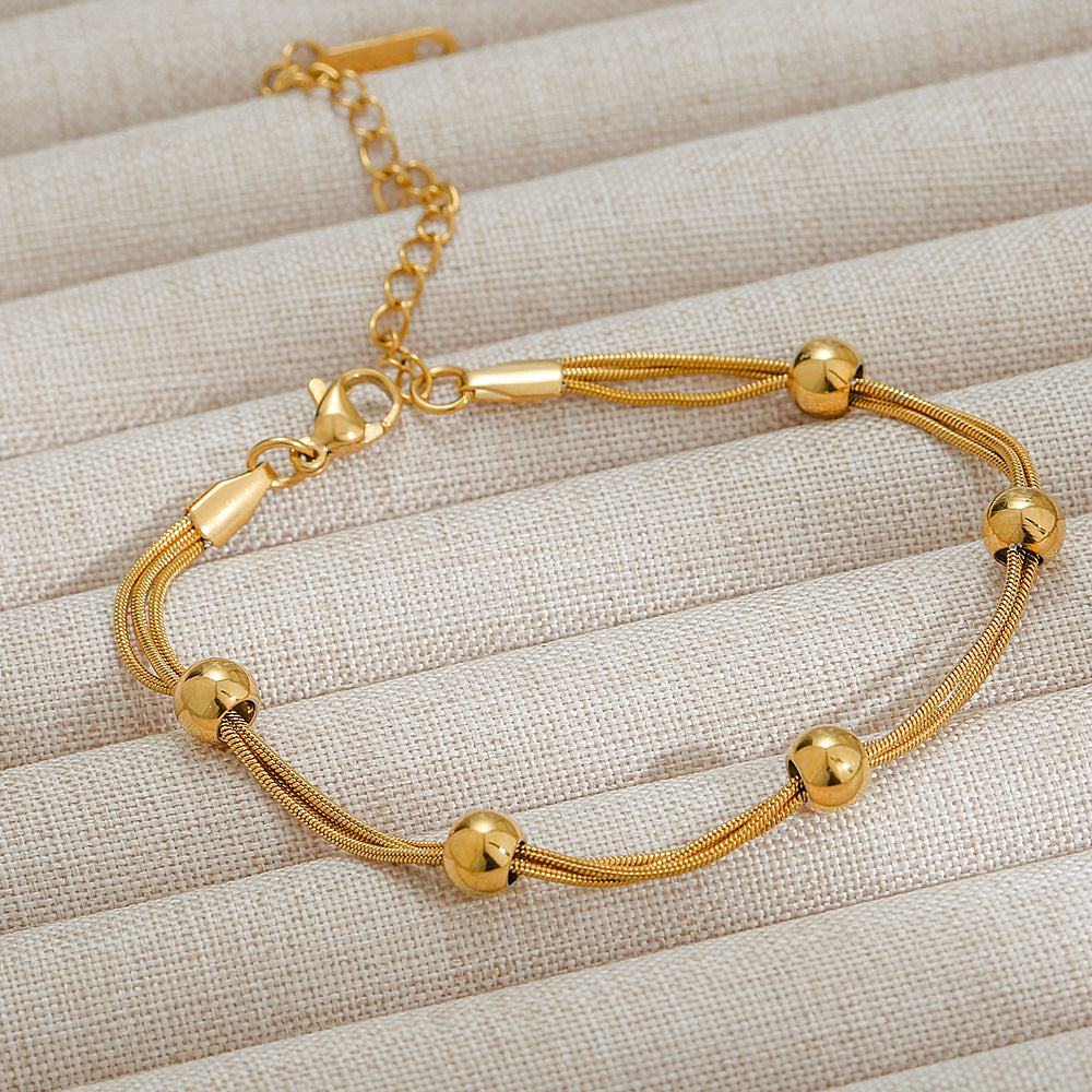 Pulsera triple cadena con balines