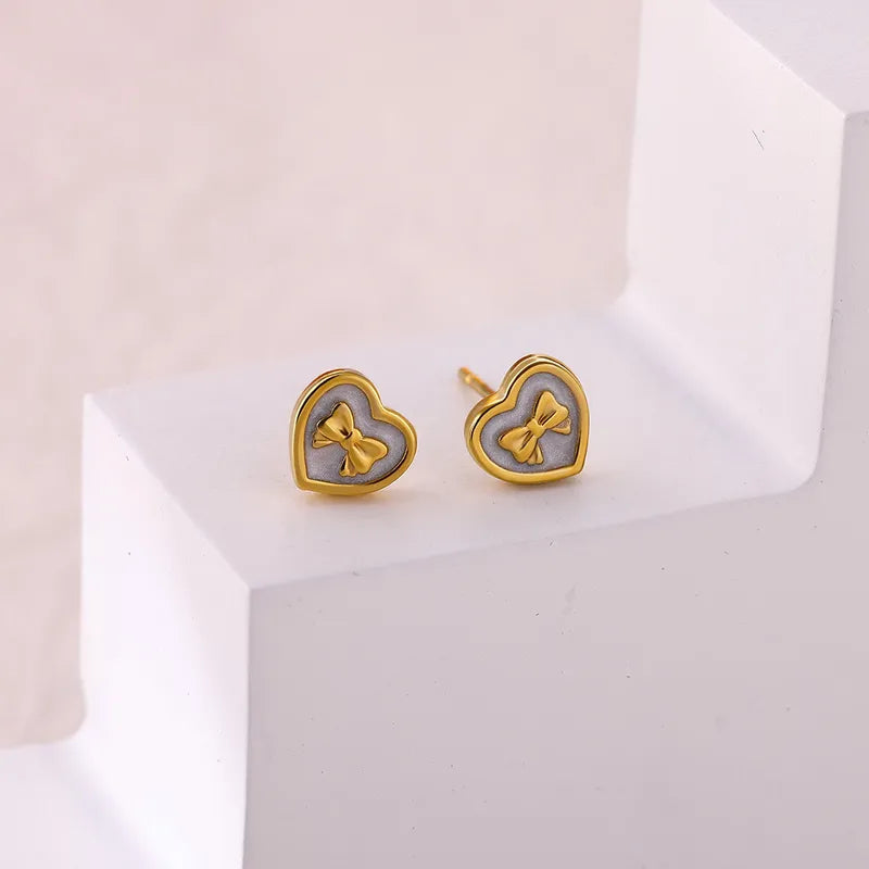 Zarcillos corazon con lazo dorado
