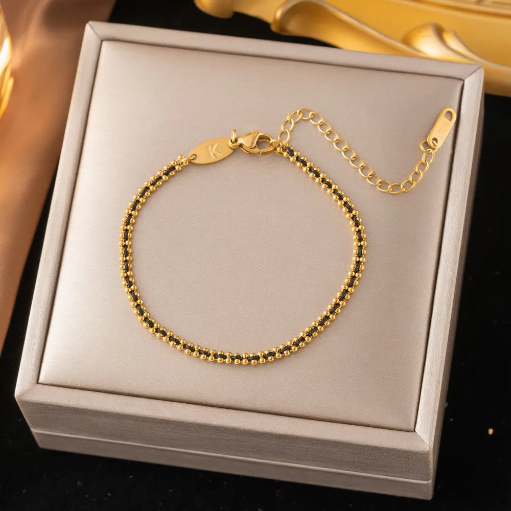 Pulsera trenzada dorado con negro