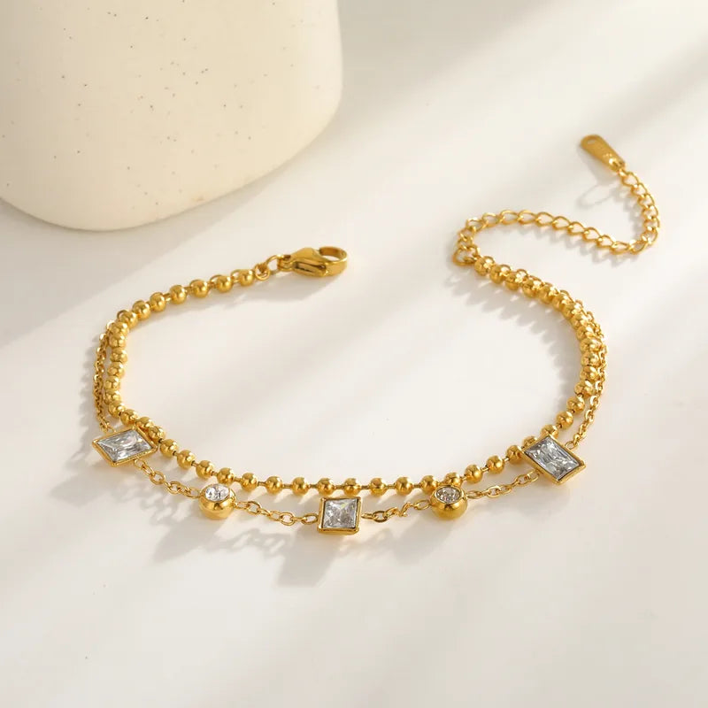 Pulsera doble con dijes cuadrados